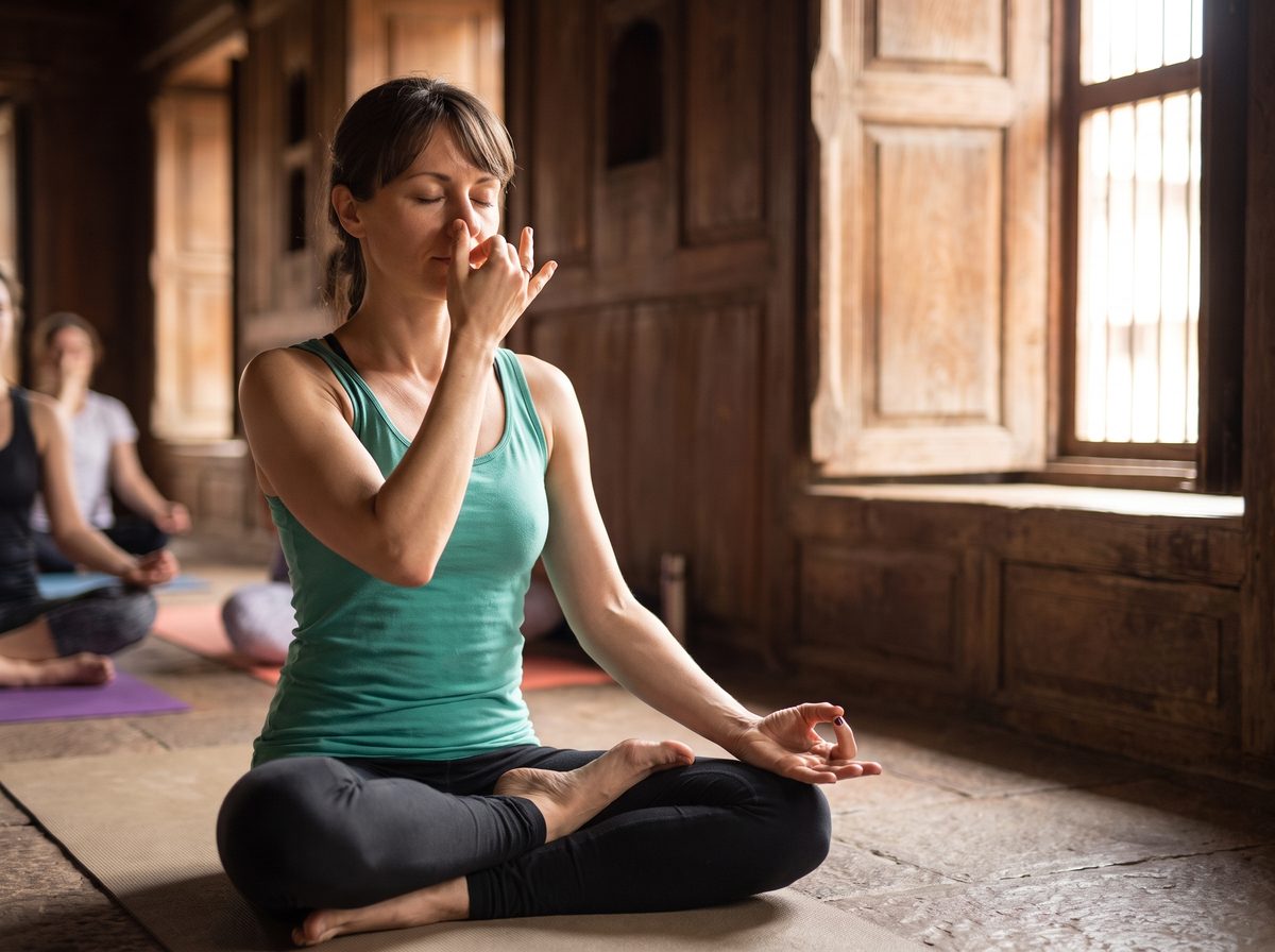 Student practicing alternate-nostril pranayama